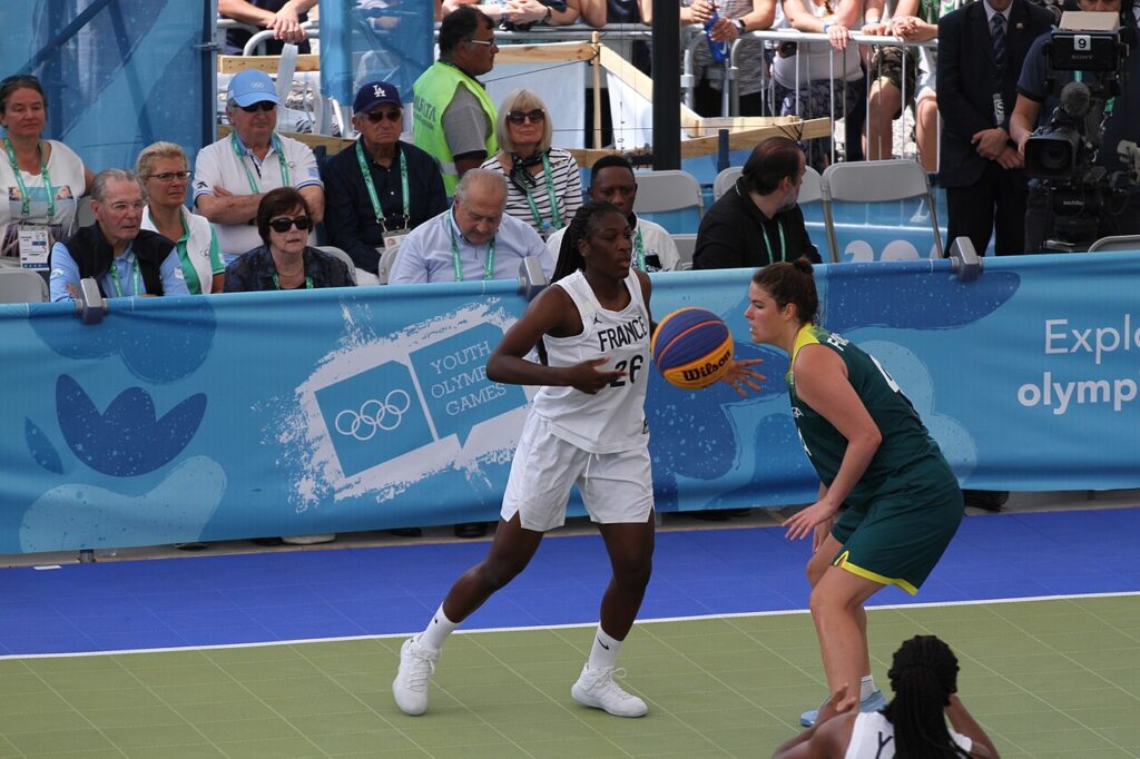 3x3 basketball players compete during an outdoor international tournament.