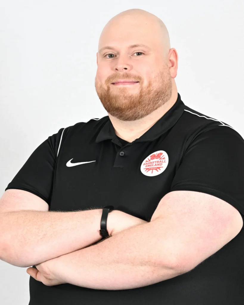 Basketball England officiating staff member wearing a branded black polo shirt