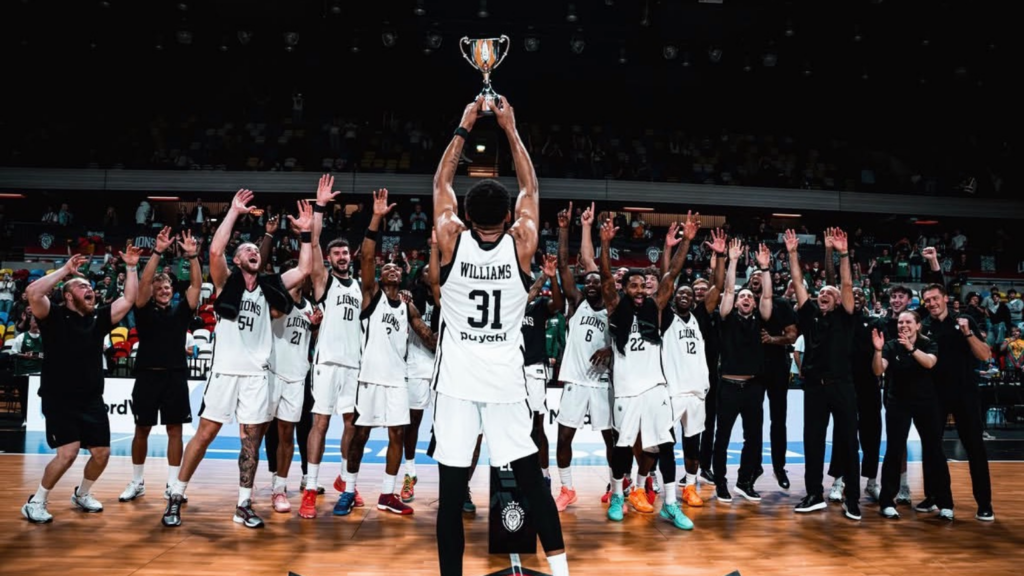 London Lions players celebrate with the London Lions Invitational trophy at the Copper Box Arena