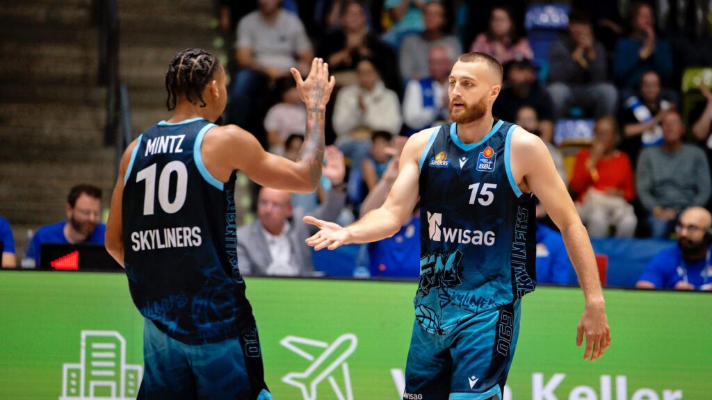 Skyliners Frankfurt guard Judah Mintz greets a team-mate during a basketball game